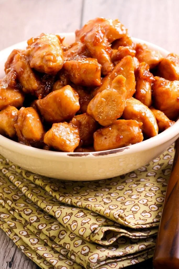 Delicious slow cooker sticky honey chicken dish garnished with herbs